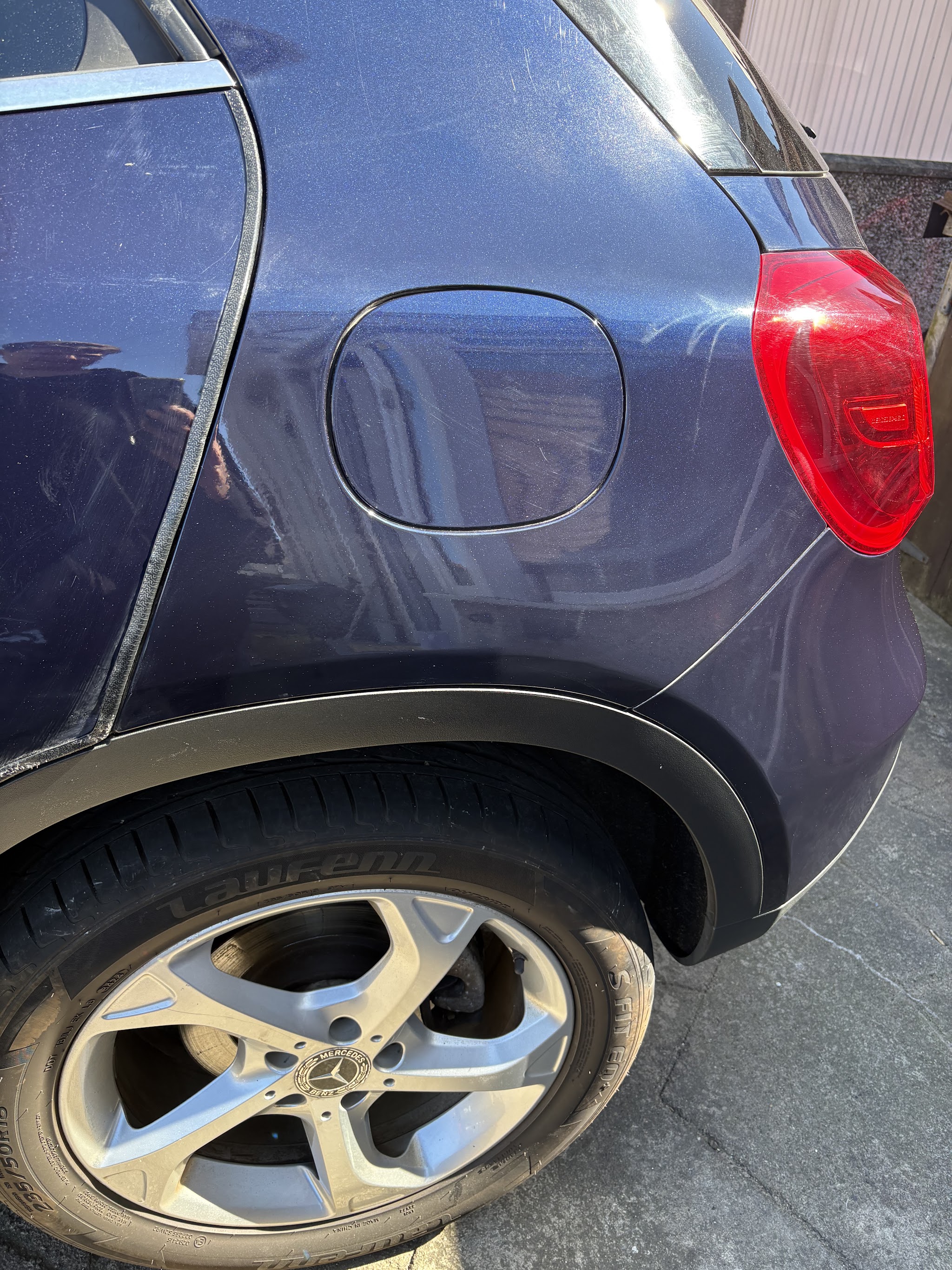 Dark blue Mercedes rear quarter panel, fuel flap and tail light